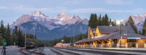 photo of a railway station in Banff, Alberta and mountains in the background